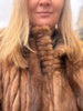 Vintage fur expert checking luxury mink coat leather flexibility