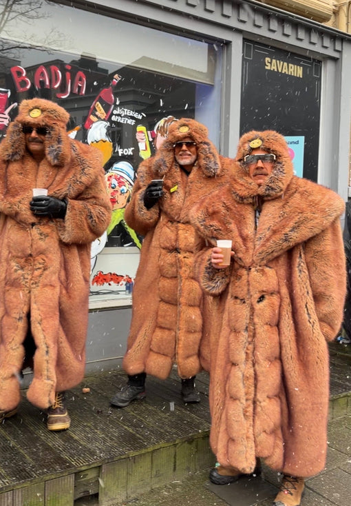 People wearing vintage fur coats during Aalst Carnaval in Belgium